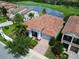 Stunning aerial view of a home by a golf course, with a beautiful lake and lush greenery at 9979 Winnington St, Orlando, FL 32832