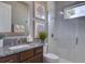 Modern bathroom featuring granite counters, glass-enclosed shower, and contemporary finishes at 9979 Winnington St, Orlando, FL 32832