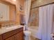 Bathroom featuring a granite-topped vanity and a tiled shower-tub combination at 9979 Winnington St, Orlando, FL 32832