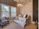 Guest bedroom with a cozy pull-out bed, brick accent wall, and chandelier at 9979 Winnington St, Orlando, FL 32832
