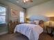 Bedroom with a ceiling fan, two windows, and warm lighting at 9979 Winnington St, Orlando, FL 32832