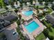 Aerial view of two community pools with palm trees, splash pad and other recreational areas at 9979 Winnington St, Orlando, FL 32832