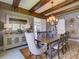 Elegant dining room with wooden beams and stylish chandelier at 9979 Winnington St, Orlando, FL 32832