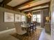 Bright dining room showcasing beamed ceilings, neutral walls, a large table, and decorative art at 9979 Winnington St, Orlando, FL 32832