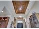 Close-up of the foyer's tray ceiling with decorative wood paneling and recessed lighting at 9979 Winnington St, Orlando, FL 32832