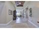 Open foyer with tiled flooring, a view into the living room, and decorative ceiling at 9979 Winnington St, Orlando, FL 32832