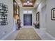 Foyer with decorative table, rug, and a view of the front doors and a bench at 9979 Winnington St, Orlando, FL 32832