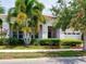 Beautiful home with well-maintained landscaping, palm trees, and neutral-toned exterior at 9979 Winnington St, Orlando, FL 32832