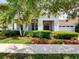 Inviting home featuring lush landscaping, a barrel tile roof, and a neutral color palette at 9979 Winnington St, Orlando, FL 32832