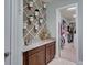 Hallway featuring a decorative wall planter and leading to a walk-in closet with custom shelving at 9979 Winnington St, Orlando, FL 32832