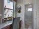Well-lit home office with built-in desk, brick accents, and adjacent half-bathroom at 9979 Winnington St, Orlando, FL 32832