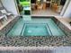 Stylish hot tub features mosaic tiling, and blends indoor and outdoor living spaces at 9979 Winnington St, Orlando, FL 32832
