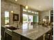 Modern kitchen with granite counters, stainless sink, and view to the backyard at 9979 Winnington St, Orlando, FL 32832