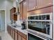 Well-equipped kitchen featuring granite counters, stainless appliances, and custom cabinets at 9979 Winnington St, Orlando, FL 32832