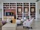 Inviting living room with custom built-in bookshelves and cozy seating arrangement at 9979 Winnington St, Orlando, FL 32832