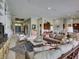Open-concept living area with tile flooring, comfortable seating, and a view into the entry hallway at 9979 Winnington St, Orlando, FL 32832