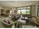 Open-concept living room with brick accent wall and view of the outdoor space at 9979 Winnington St, Orlando, FL 32832