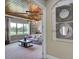 Comfortable living room with wood paneled ceiling and large windows overlooking the outdoor space at 9979 Winnington St, Orlando, FL 32832