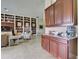 Spacious living room featuring a custom built-in bookcase and granite counter dry bar at 9979 Winnington St, Orlando, FL 32832