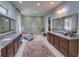 A spacious main bathroom showcases dual vanities, granite countertops, and a glass enclosed shower at 9979 Winnington St, Orlando, FL 32832