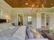 This main bedroom features a decorative ceiling, an elegant chandelier, and plenty of space at 9979 Winnington St, Orlando, FL 32832