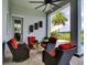 Outdoor living area features stylish seating, a ceiling fan, and view of a golf course at 9979 Winnington St, Orlando, FL 32832