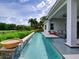Backyard pool with stone waterfall feature and a covered patio at 9979 Winnington St, Orlando, FL 32832