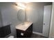 Updated bathroom with a modern vanity, stylish light fixture, and a round mirror at 1019 S Hiawassee Rd # 3811, Orlando, FL 32835