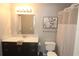 Updated bathroom featuring marble vanity top, framed mirror, and shower with curtain at 1019 S Hiawassee Rd # 3811, Orlando, FL 32835