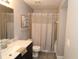 Cozy bathroom with marble countertop, modern sink, and updated shower with curtain at 1019 S Hiawassee Rd # 3811, Orlando, FL 32835