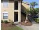 Inviting apartment complex featuring stairs leading to the second floor entrance with a small palm tree at 1019 S Hiawassee Rd # 3811, Orlando, FL 32835
