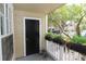 Charming front porch with a private entrance, a black door, and potted ferns at 1019 S Hiawassee Rd # 3811, Orlando, FL 32835