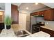 Modern kitchen with granite countertops, stainless steel appliances and dark brown cabinetry at 1019 S Hiawassee Rd # 3811, Orlando, FL 32835