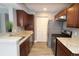 Updated kitchen showcasing granite counters, wood cabinets and stainless steel appliances at 1019 S Hiawassee Rd # 3811, Orlando, FL 32835