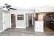 Open-concept living room with plank flooring, gray walls and an open pass-through to the kitchen at 1019 S Hiawassee Rd # 3811, Orlando, FL 32835