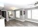Bright living room with modern gray walls, plank flooring, large windows and sliding glass door at 1019 S Hiawassee Rd # 3811, Orlando, FL 32835