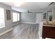 Comfortable living space with gray walls, plank flooring and a view into the updated kitchen at 1019 S Hiawassee Rd # 3811, Orlando, FL 32835