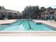 Large community pool with lounge chairs, tables, and well-maintained landscaping at 1019 S Hiawassee Rd # 3811, Orlando, FL 32835