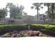 Community entrance sign landscaped with green shrubbery and colorful flowers in the Tradewinds Metrowest Condominium at 1019 S Hiawassee Rd # 3811, Orlando, FL 32835