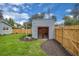 Shed with double doors, surrounded by green grass and a wooden fence at 1021 S Elm Ave, Sanford, FL 32771