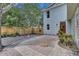 Charming backyard featuring brick pavers, a wooden fence, and lush landscaping at 1021 S Elm Ave, Sanford, FL 32771
