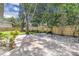 Spacious backyard featuring a paver patio, lush greenery, and a wood fence at 1021 S Elm Ave, Sanford, FL 32771