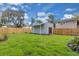 Large backyard with a well-maintained lawn, shed, and wooden fence at 1021 S Elm Ave, Sanford, FL 32771