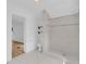 Modern bathroom featuring a tiled shower, toilet, and access to another room at 1021 S Elm Ave, Sanford, FL 32771