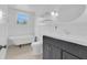 Charming bathroom features a clawfoot tub, classic fixtures, and black-and-white mosaic tile floor at 1021 S Elm Ave, Sanford, FL 32771
