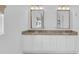 Bathroom vanity with double sinks, granite countertop, and white cabinetry at 1021 S Elm Ave, Sanford, FL 32771