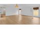 Bright bedroom with wood floors, windows with blinds, and modern lighting fixture at 1021 S Elm Ave, Sanford, FL 32771