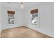 Bright bedroom with hardwood floors and two windows with woven shades at 1021 S Elm Ave, Sanford, FL 32771