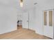Bright bedroom with hardwood floors, woven closet doors, and a glimpse of the staircase at 1021 S Elm Ave, Sanford, FL 32771