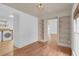 Bonus room with built-in bookshelves, hardwood floors, and a washing machine visible at 1021 S Elm Ave, Sanford, FL 32771